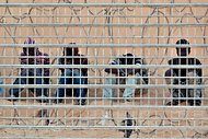 African asylum seekers waited on the Egyptian side of the border fence with Israel in early September. The trip for those trying to cross from Egypt to Israel has become increasingly dangerous as criminal gangs in Sinai have taken migrants and asylum seekers hostage.